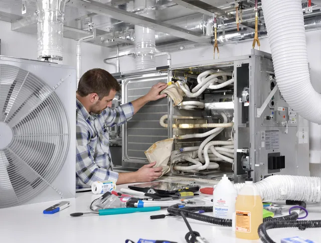 North Smithfield Air Duct Cleaning specialist performing precision AC coil cleaning in North Smithfield