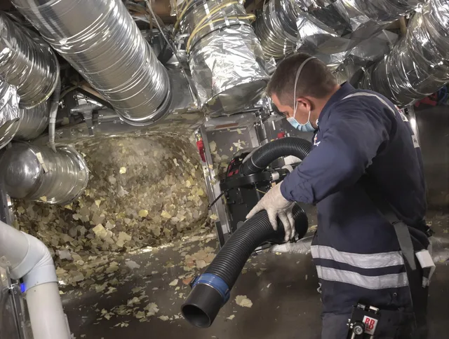 North Smithfield Air Duct Cleaning specialist operating negative pressure cleaning equipment for thorough duct maintenance in North Smithfield