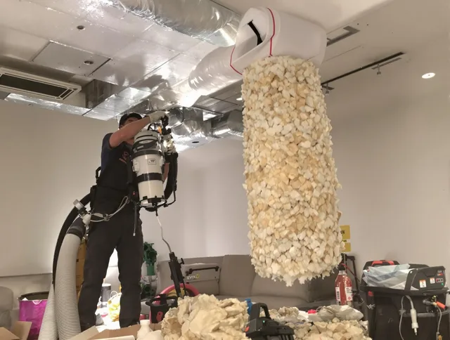 North Smithfield Air Duct Cleaning technician performing precision vacuum insulation removal in a residential property in North Smithfield